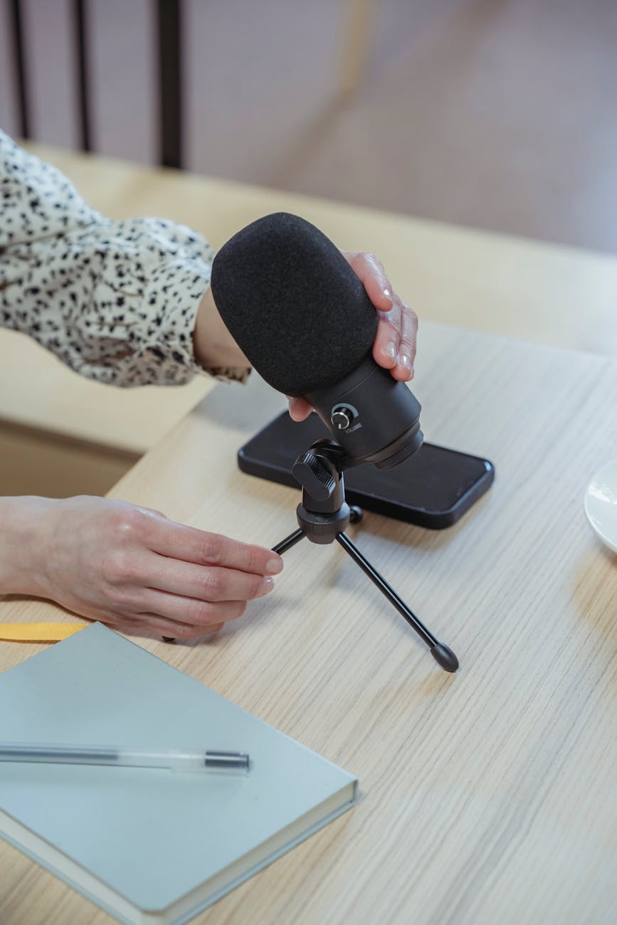 anonymous woman putting microphone on table before conference in office